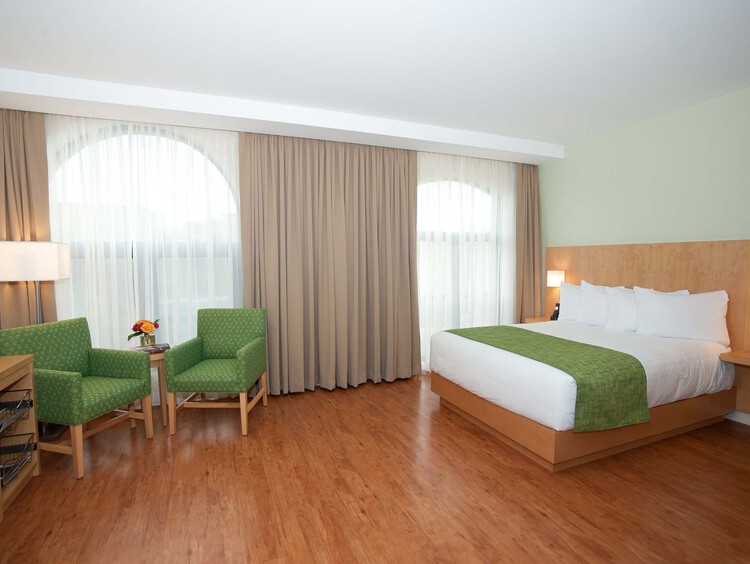Holman Accessible Queen room with two green armchairs