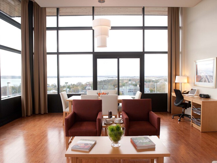 Living room with seating and floor to ceiling windows