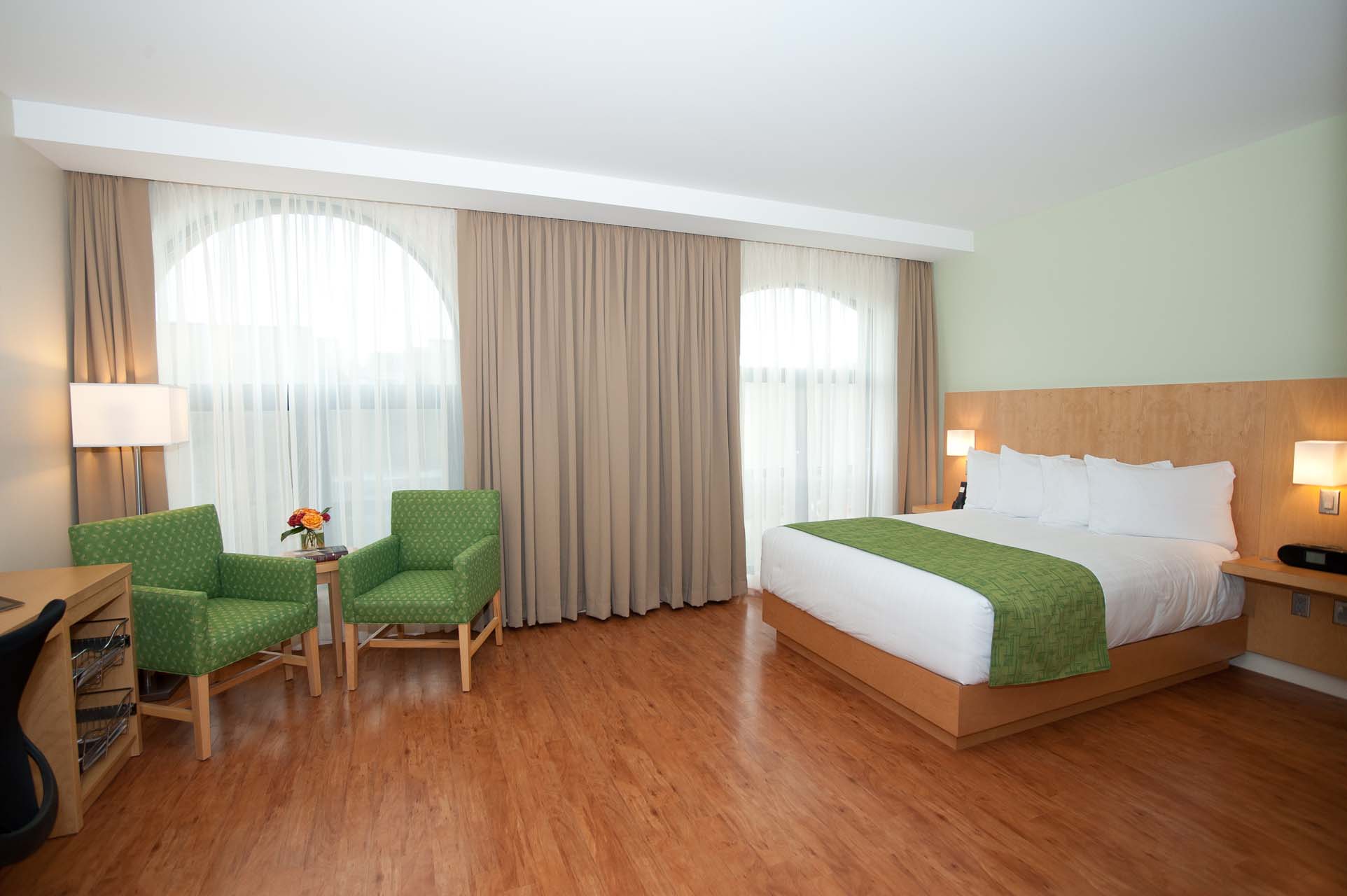 Holman Accessible Queen room with two green armchairs