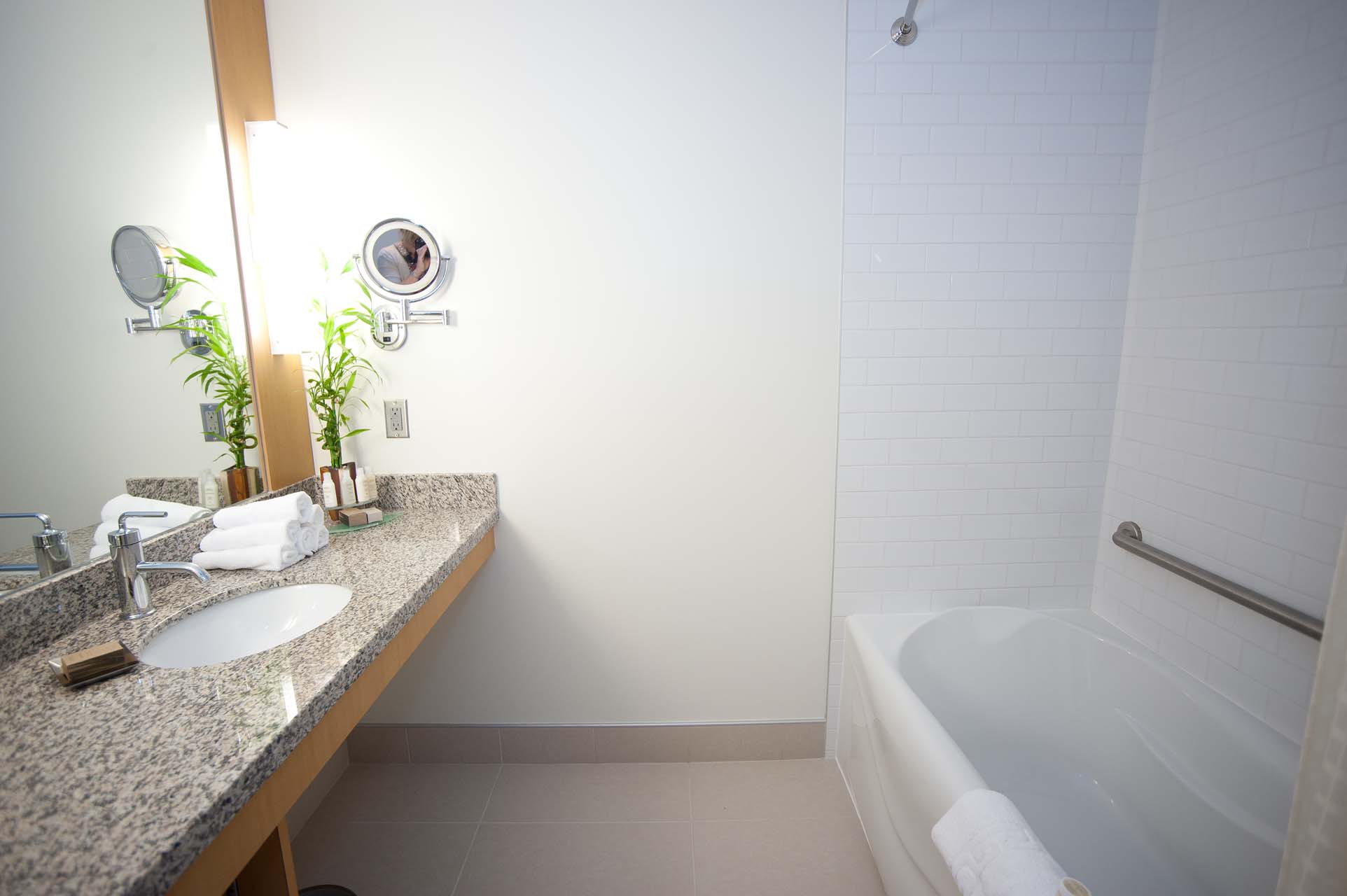 A bathroom with a tub and a grab bar