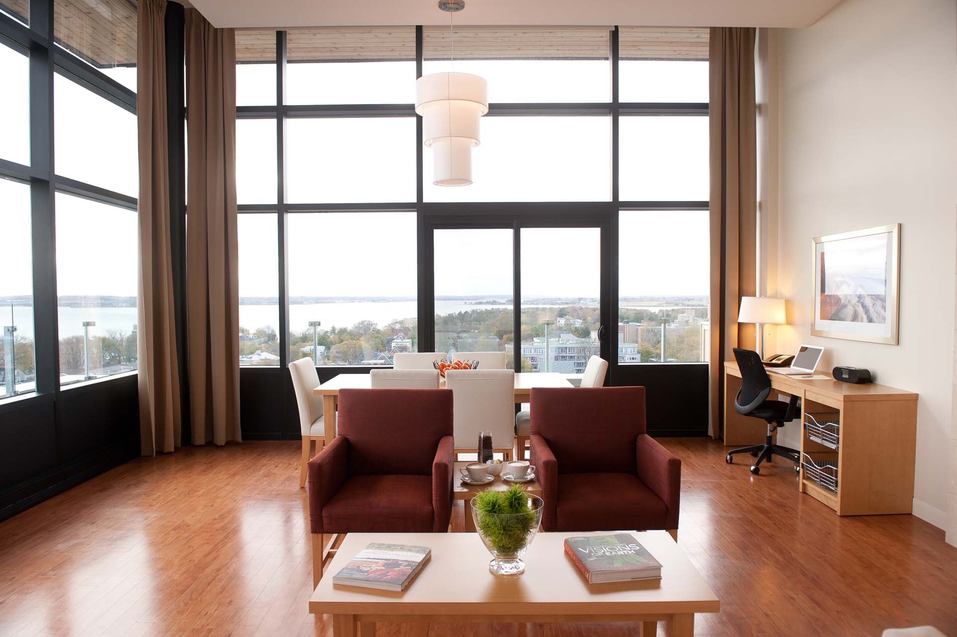 Living room with seating and floor to ceiling windows