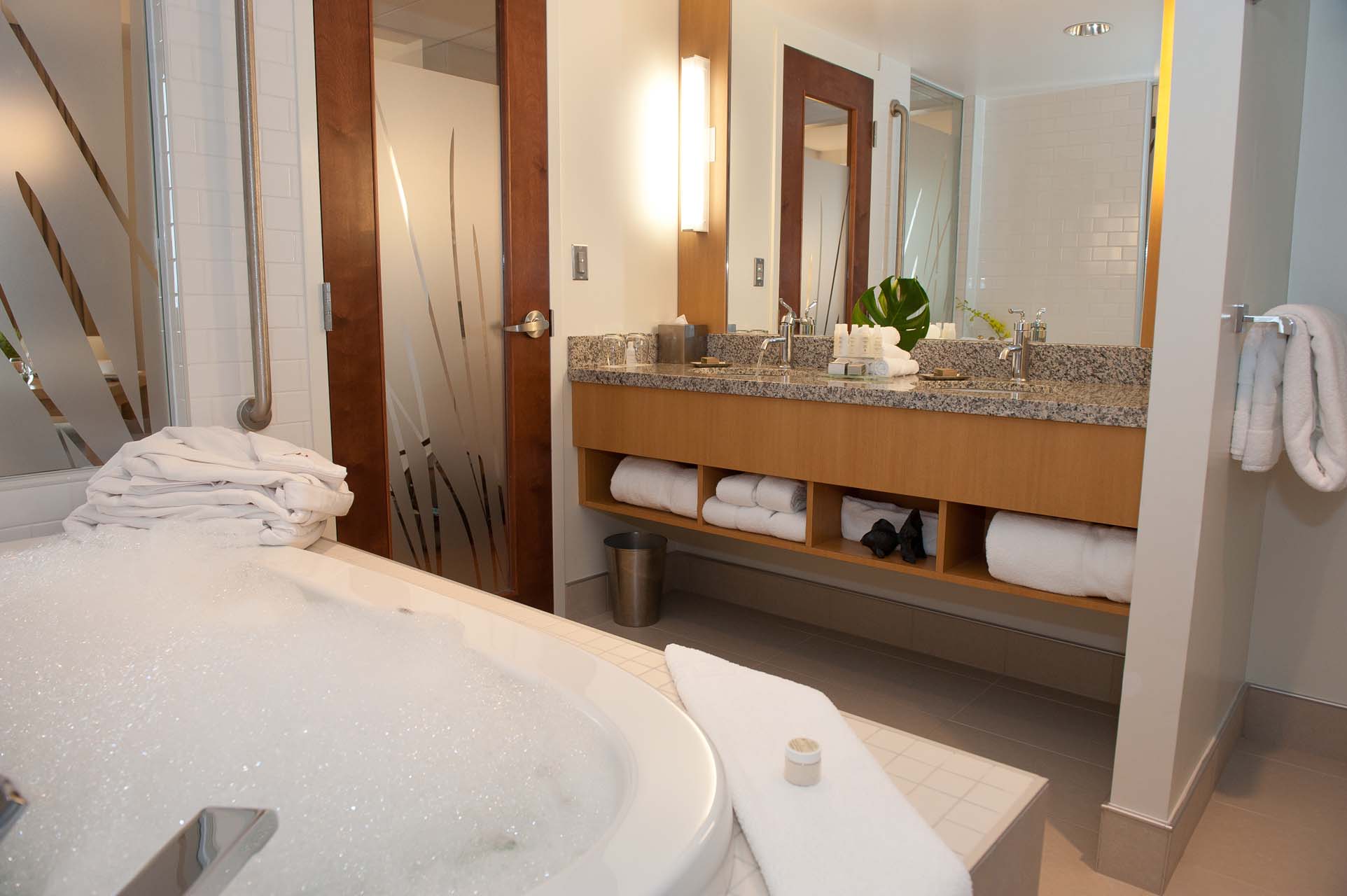 Bathroom with a tub and a double sink