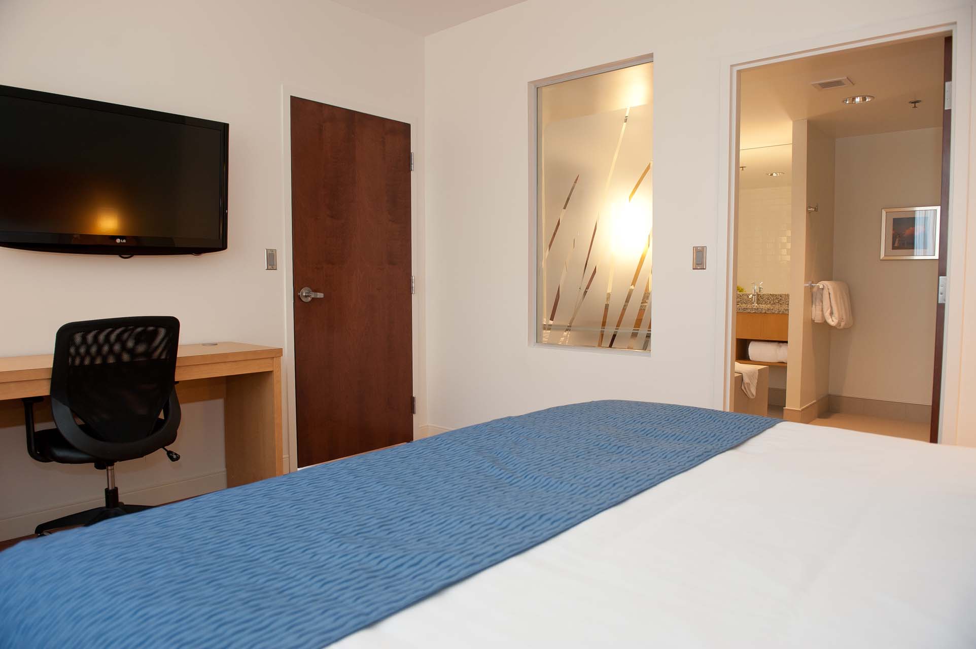 Guest bedroom with a king bed and a work desk