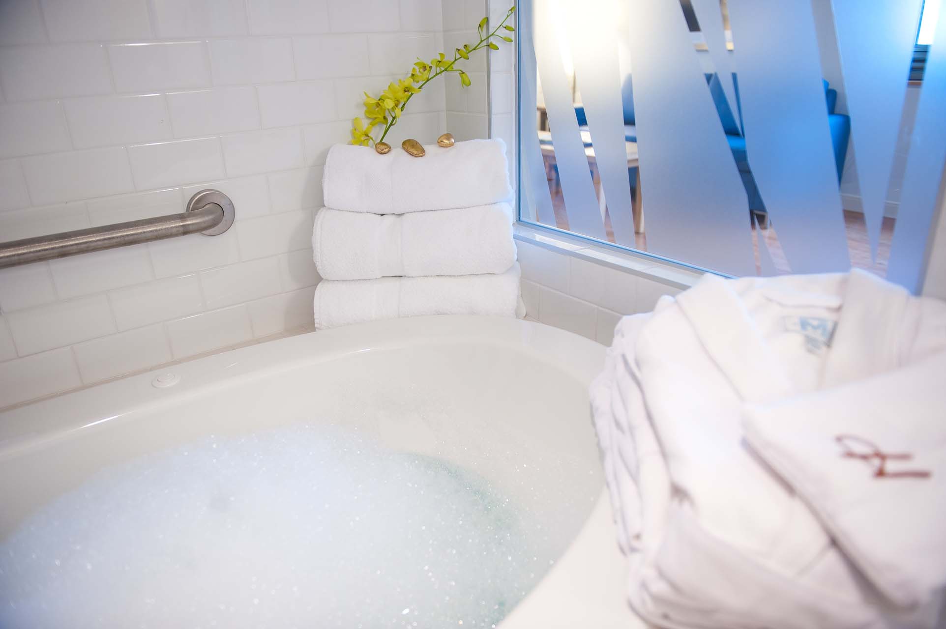 Closeup of a tub with folded bathrobes
