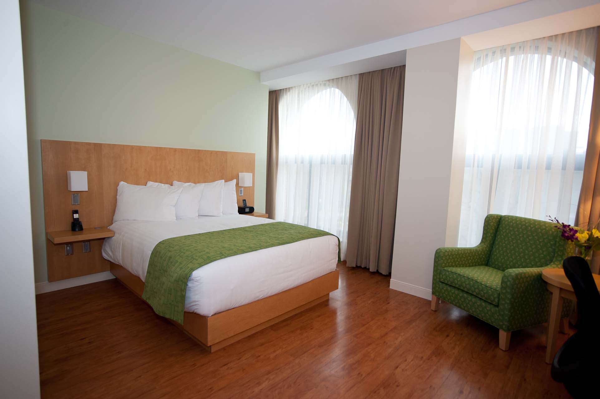 Holman 1 Queen guest room with an armchair