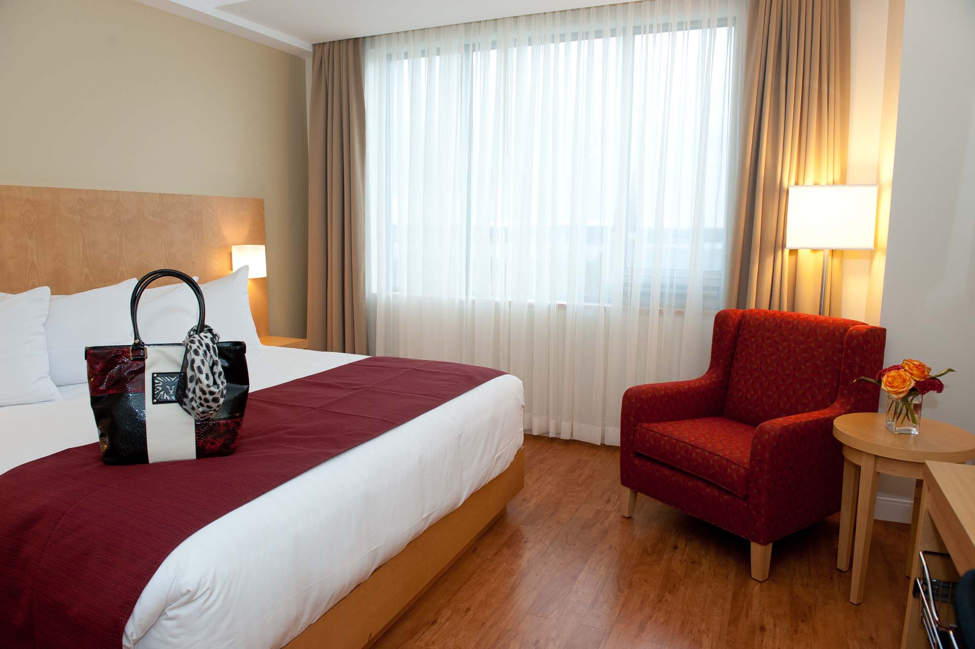 Guest with a king bed and an armchair