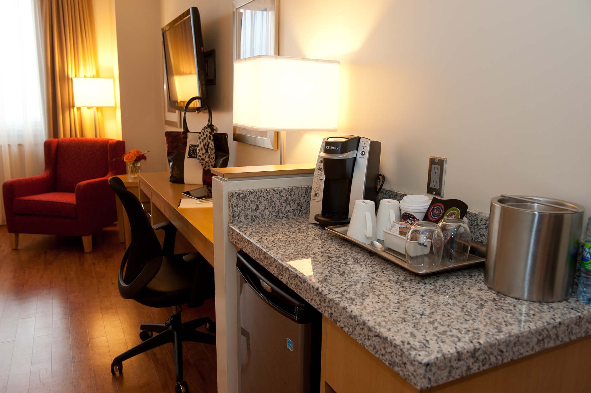 A counter with a coffee machine and mugs