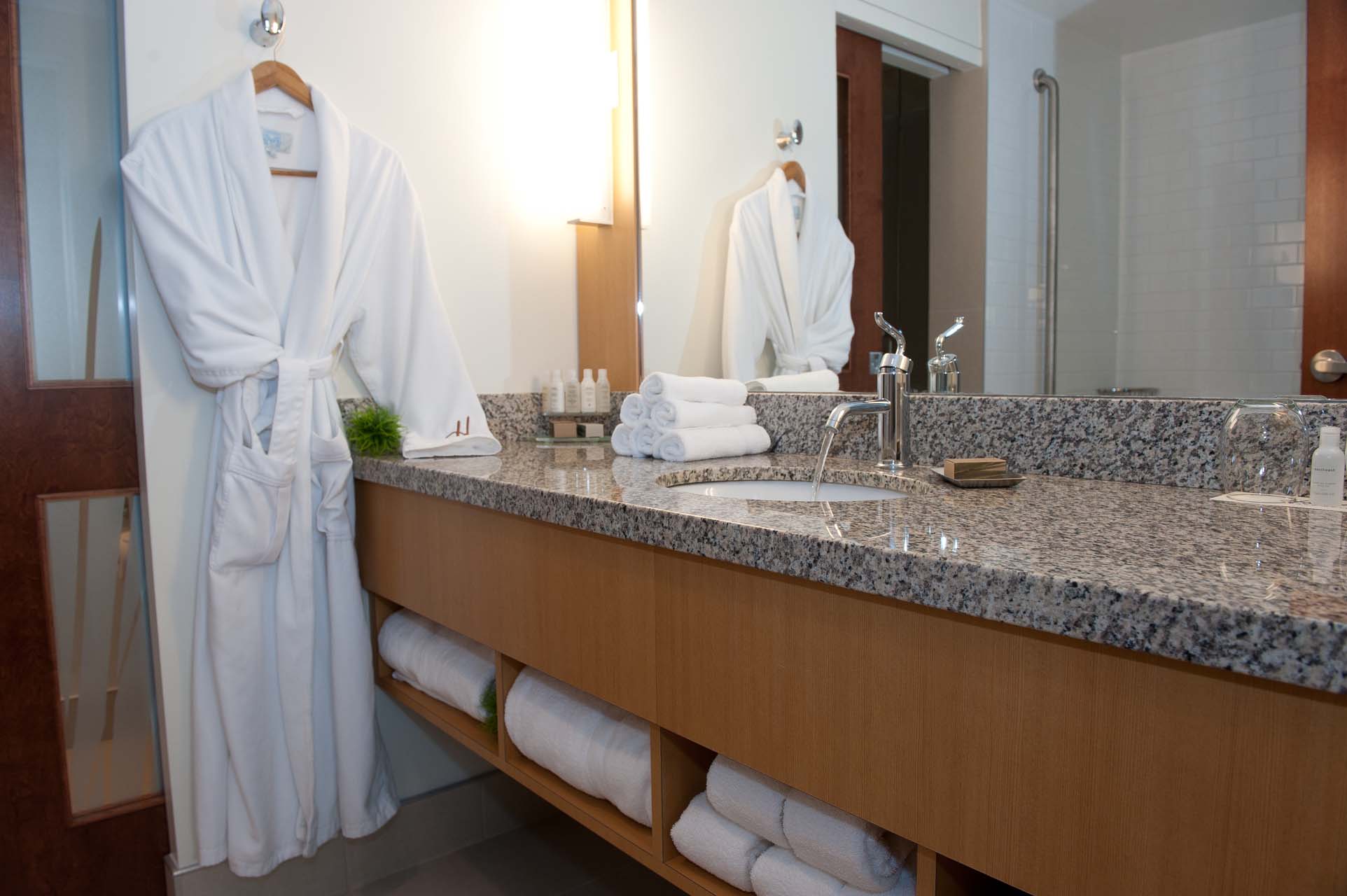 Bathroom with a bathrobe hanging on the wall