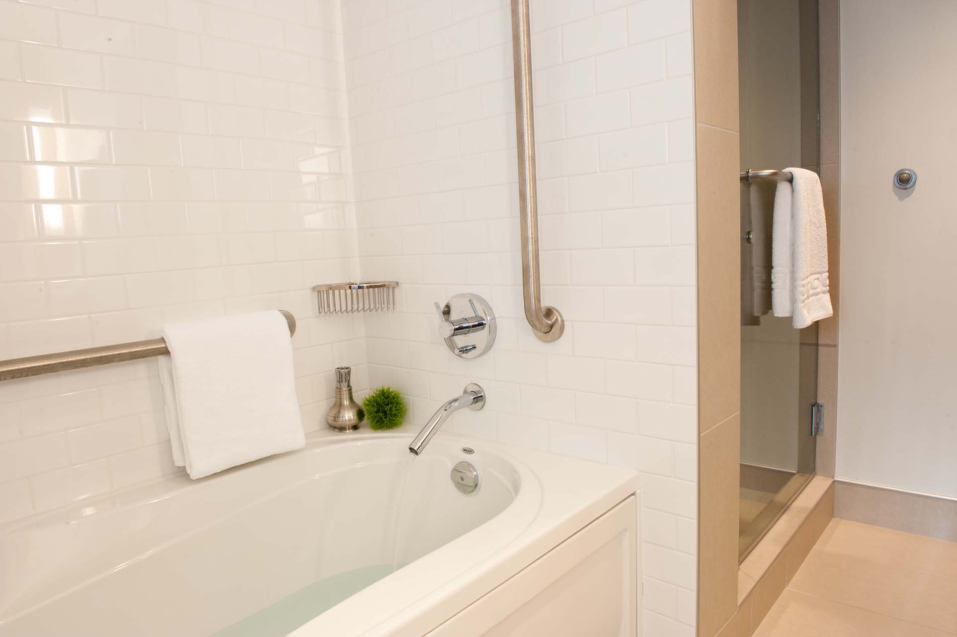 A bathroom with a tub and a walk-in shower