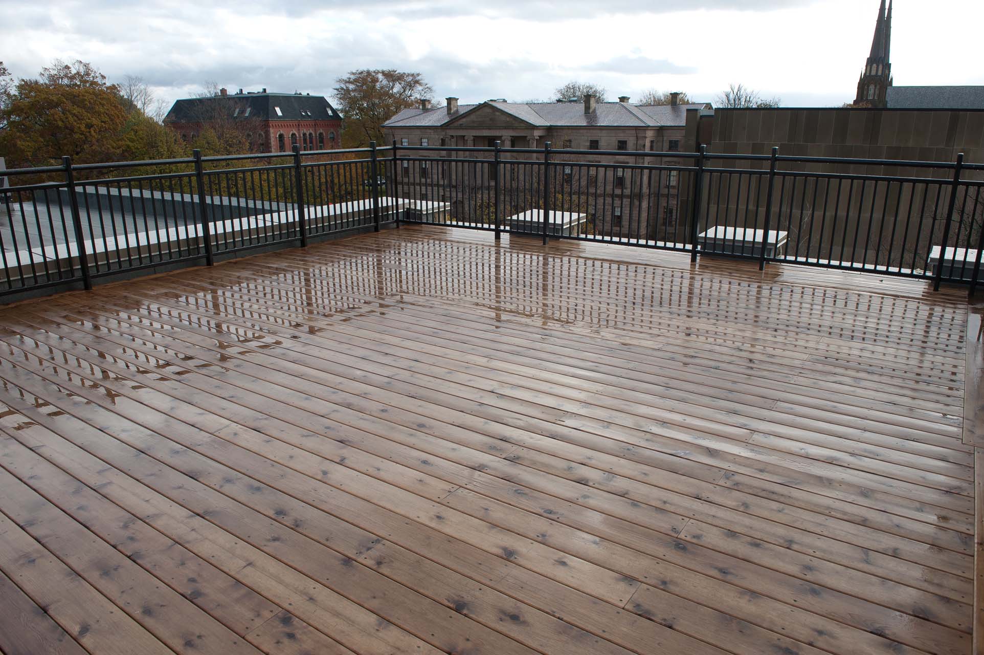 A large wooden deck with a view of the city